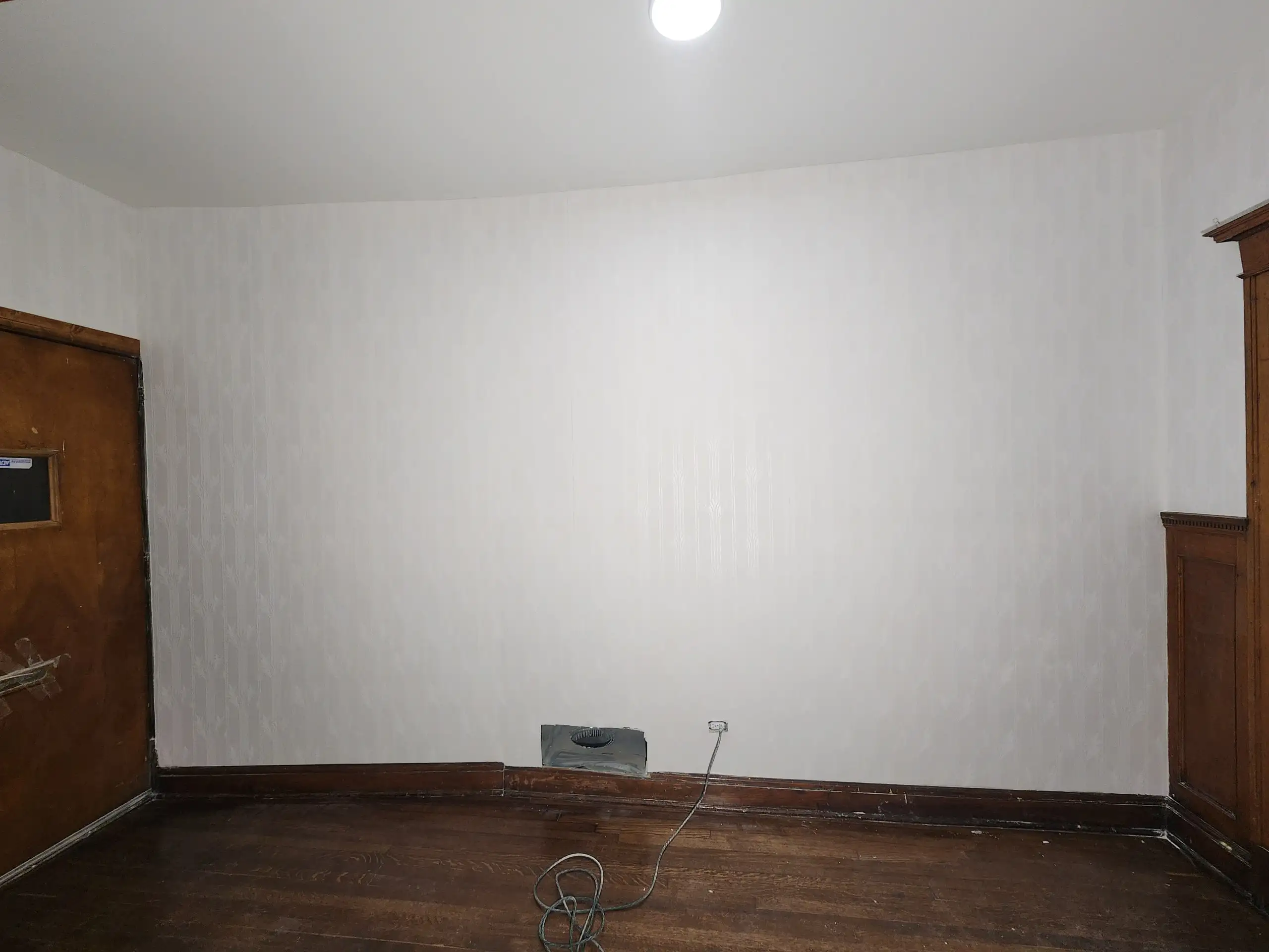 Room with a plain wall ready for a considered wallcovering decision